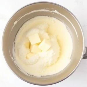 In a large mixing bowl, cream the softened butter and sugar together until