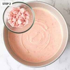 Mix the strawberry cake mix, melted butter, and egg in a large bowl until smooth. Pour the batter into the prepared baking dish, spreading it evenly across the bottom.