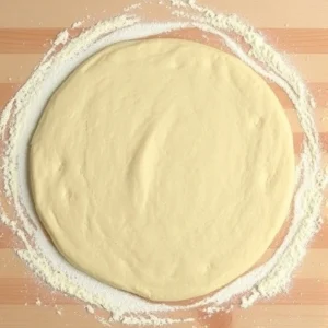 Turn the dough out onto a lightly floured surface and roll it out to