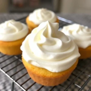 While the cakes are cooling, make the whipped cream by beating the heavy cream with powdered sugar and vanilla extract in