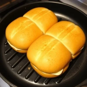 Toast the sandwich buns on the grill or in a pan for 1-2 minutes.