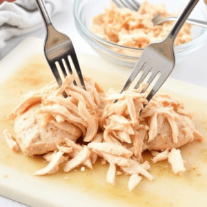 In a large bowl, combine the shredded chicken, chopped celery, red grapes, almonds, and green onions