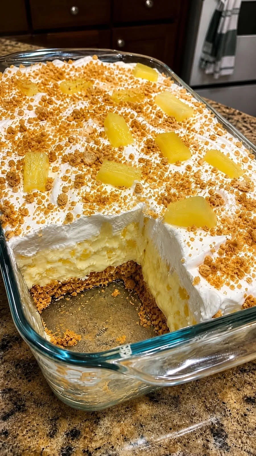 Creamy no-bake pineapple dessert served in a bowl with fresh pineapple slices