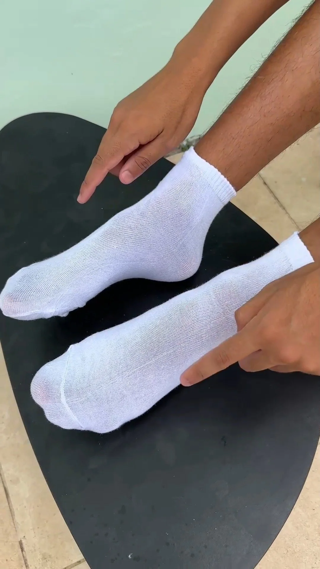 A person sleeping comfortably with socks on in a cozy bedroom.